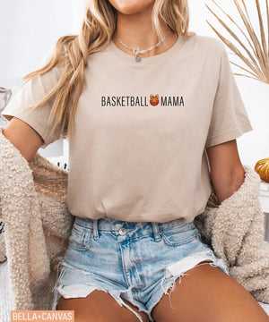 Person wearing tan Bella Canvas t-shirt with 'Basketball Mama' text and graphic.