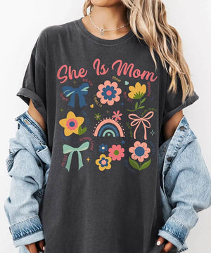 She Is Mom Comfort Colors® T-Shirt – Floral & Bow Inspirational Mom Shirt - Woven Mama