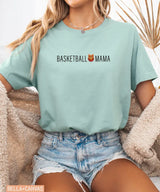 Person wearing dusty blue Bella Canvas t-shirt with 'Basketball Mama' text and graphic.