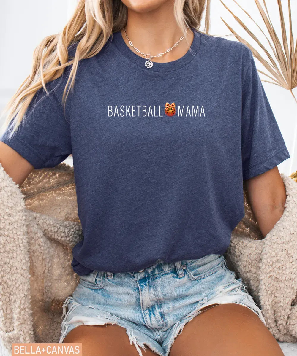 Person wearing heather navy Bella Canvas t-shirt with 'Basketball Mama' text and graphic.