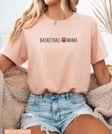 Person wearing heather peach Bella Canvas t-shirt with 'Basketball Mama' text and graphic.
