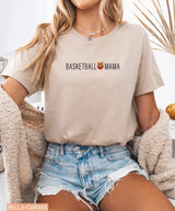 Person wearing tan Bella Canvas t-shirt with 'Basketball Mama' text and graphic.