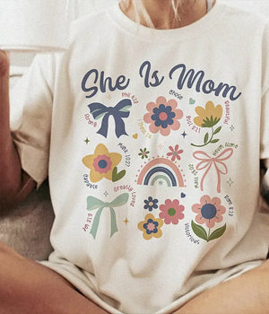 She Is Mom Comfort Colors® T-Shirt – Floral & Bow Inspirational Mom Shirt - Woven Mama